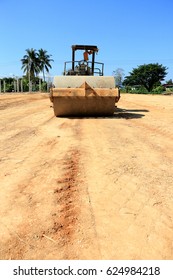 Front View Of The Old Steamroller A Modern Road Roller With Yellow Color Compactor Soil For Adjust Level On Construction Site.