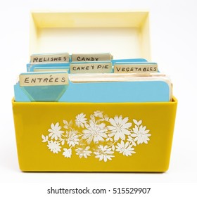 Front View Of Old Yellow And Orange Recipe Box With Handwritten Recipe Tabs.