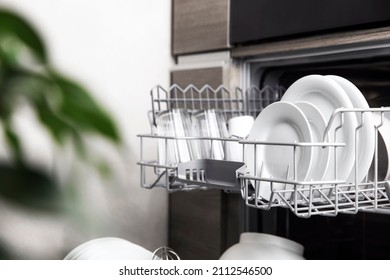 Front view of open automatic stainless fully integrated dishwasher range machine with clean utensils, cutlery, inside at modern home kitchen. Household domestic, kitchen appliances, lifestyle view - Shutterstock ID 2112546500