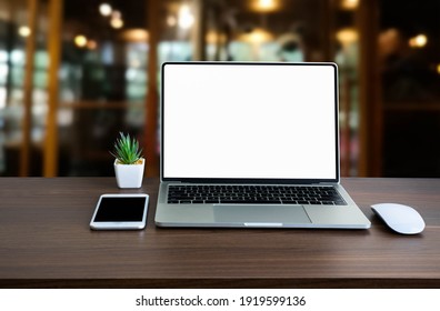 Front View Of Open Laptop Computer Notebook With Blank Monitor White Screen Display On Work Table Desk. Workspace Office Modern For Job Business Online Communication Technology In Shop Or Home Indoor.