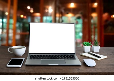 Front view of open laptop computer notebook with blank monitor white screen display on work table desk. Workspace office modern for job business online communication technology in shop or home indoor.