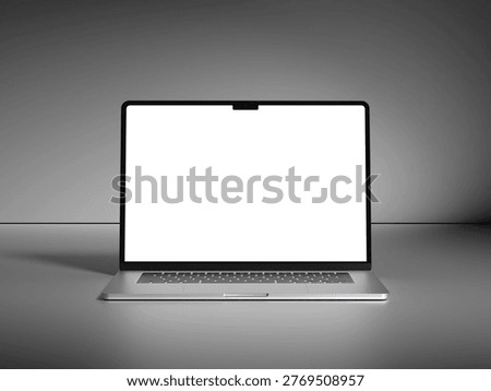 Front view of an open silver laptop with a blank white screen on a gray surface.