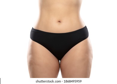 Front view. Overweight woman with fat cellulite legs and buttocks, obesity female body in black underwear isolated on white background. Orange peel skin, liposuction, healthcare and beauty treatment.