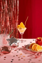 Front View Of A Plate Of Fresh Fruit, A Smoothie, Colored Candles Inside A Glass And Two Star-shaped Balloons. Sparkling Strings Hang On A Red Background.