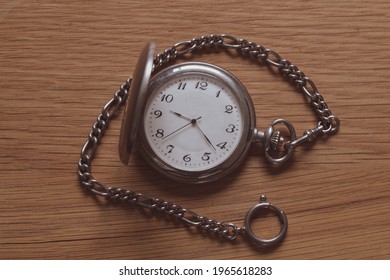 Front view of a pocketwatch on a wooden background