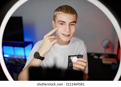 Front View Portrait Of Blonde Young Man Filming Male Skincare Tutorial With Ring Light, Copy Space