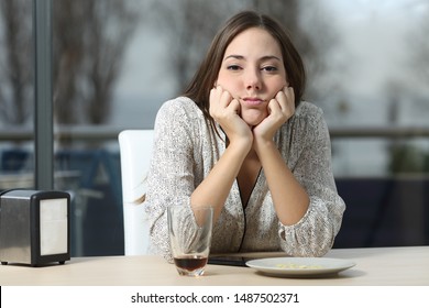 Front View Portrait Of A Bored Woman In A Bar Looking At You A Sad Winter Day