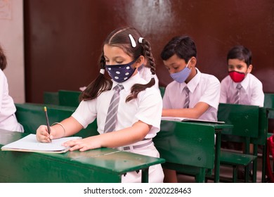Front view portrait of child with face mask back at school after covid-19