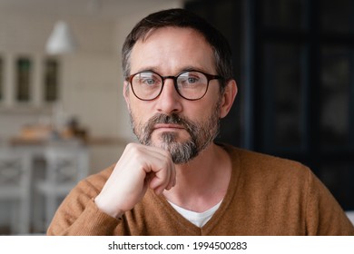 Front view portrait of a confident thoughtful pensive Caucasian middle-aged mature man teacher father freelancer wearing glasses looking at camera at home. - Powered by Shutterstock