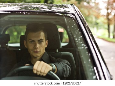 Front View. Portrait Of A Handsome Man Driving His Car