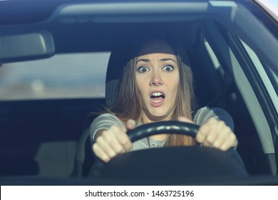 Front view portrait of an scared driver driving a car before an accident - Shutterstock ID 1463725196