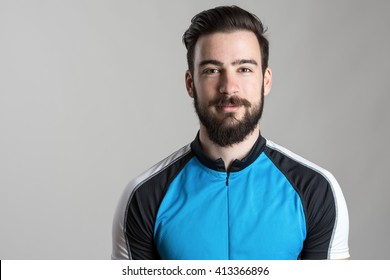 Front view portrait of smiling happy cyclist wearing cycling jersey t-shirt over gray studio background.  - Powered by Shutterstock