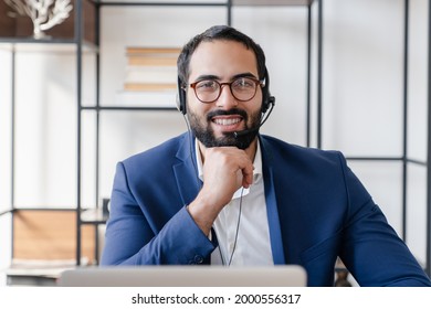 Front View Portrait Of A Video Call Of Middle Eastern Businessman IT Support Hot Line Worker On Zoom Conversation Online. Male Tutor Teacher Lecturer Conducting Lessons Remotely