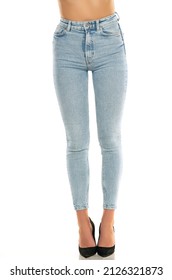 Front View Of Pretty Female Legs In Jeans And Shoes On White Background