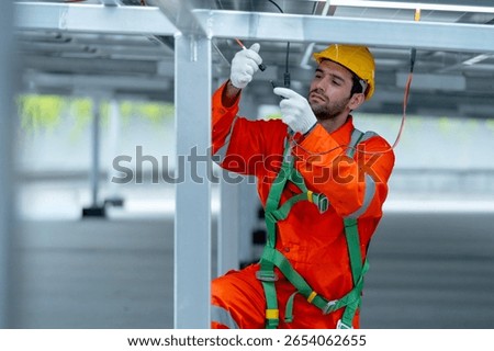 Front view professional technician worker or engineer work with maintenance or check system under solarcell panel.