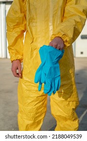 Front View Of Protective Gloves And Yellow Overalls.