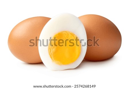 Front view of raw brown chicken eggs and cooked or boiled chicken egg with egg yolk in half in stack is isolated on white background with clipping path.