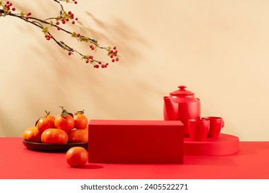 Front view of a red podium placed in the center of the frame, a tea set and a plate of tangerines on the table. Scene for advertising cakes and candy on Tet holiday. - Powered by Shutterstock