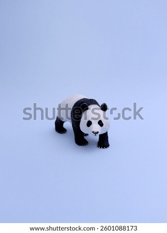 Front view rubber panda bear toy on blue background