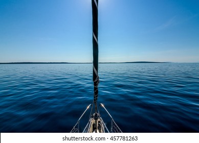 Front view of sailing boat on the sea. Bow side of yacht or sail boat gliding through calm sea in Adriatic sea on the sunny day.
