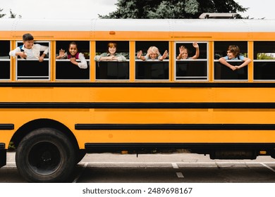 Front view of schoolchildren classmates pupils looking out of the school bus waiting for new educational year semester, coming back to school lessons and homework. - Powered by Shutterstock