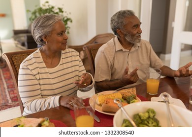 Front View Of A Senior African American Couple Sitting Together On Dining Table At Home