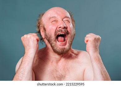 Front View Senior Man Holding Hands In Fist In Front Of Scream Looking Up Mouth Open Bald Mustache Beard Expression Face. Person Show Strong Emotion He Is Capable Of. Studio Isolated Blue Background.