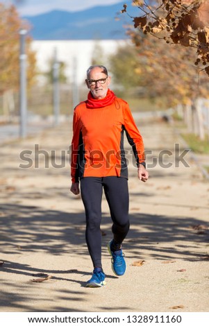 Similar – Senior runner man sitting after jogging in a park