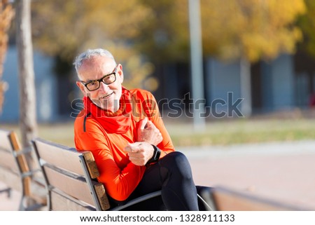 Similar – Senior runner man sitting after jogging in a park