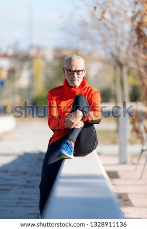 Similar – Senior runner man sitting after jogging in a park