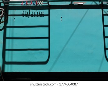 Front View Of The Shadow Of Coat Hanger Outside The Window. Abstract Design With Pattern Of Dark Parallel Lines And Geometric Shapes. Little Summer