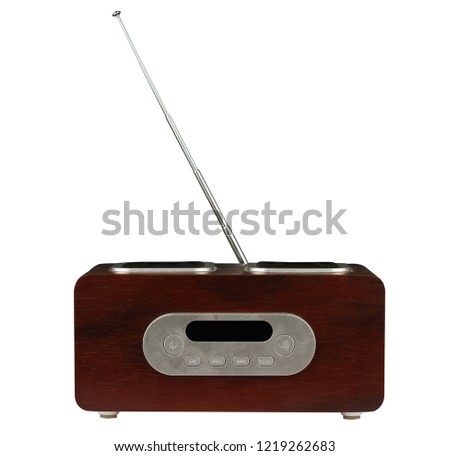 front view of small retro radio with brown wooden finish and metallic elements isolated on white