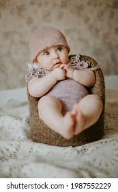 Front view of small toddler sitting at the chair. Concept of baby photoshoot.