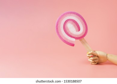Front view of sponge and hand on plain background
