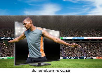 Front view of sportsman practising discus throw against american football arena - Powered by Shutterstock