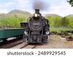 A Front View of Steam Locomotive 491 Steaming in a Train Yard