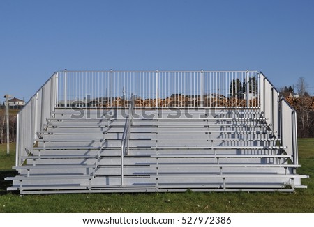 Front view of sturdy steel galvanized portable bleachers in the field