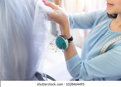 Front View Of Successful Wedding Dressmaker Owner Measuring Materials On Mannequin In Office Or Workshop. Talented Female Seamstress Working With Textile For Sewing Clothes