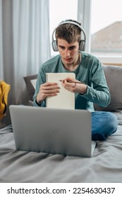 Front view of a teenage boy doing a task on the online class at home - Shutterstock ID 2254630437