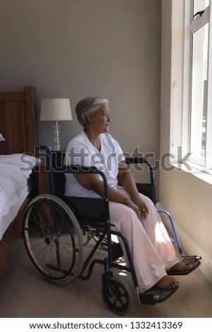 Similar – Senior woman in a wheelchair alone in a room