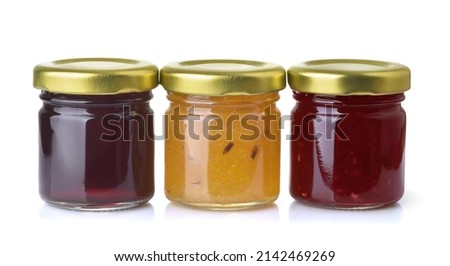 Front view of three different jam jars isolated on white