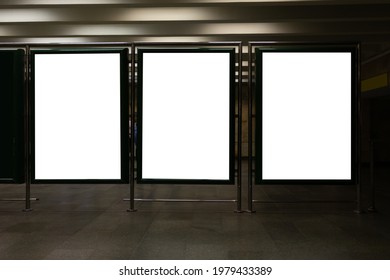 Front View Of Three Empty White Billboard Screens At The Metro Station. Mock Up. Blank Advertising Billboards In The Subway 
