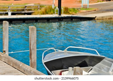 Front view of a tinnie or aluminium dingy, moored at a wooden jetty.
Aluminum hire dingy ready to go. - Powered by Shutterstock