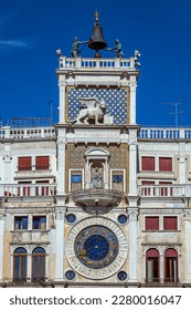 Front view of Torre dell'Orologio located in San Marco Square, Venice, Italy. Renaissance tower from 1499 with city views and mechanical clock with symbolic decorations.