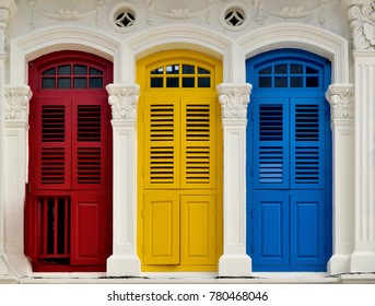 Front view of traditional vintage Singapore shop house or shophouse with antique red, blue and yellow wooden shutters in historic Little India
  - Powered by Shutterstock