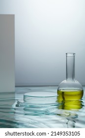 Front view of transparent podium and yellow water in laboratory equipment and water background
