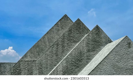Front view of triangles against sky