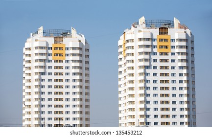 Front view of two constructed buildings over clear blue sky