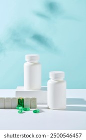Front view of two white bottles unlabeled displayed on white podiums with medicine daily box and green capsules on blue background. Minimal style for advertising medicine product