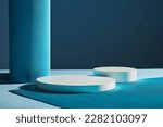 Front view of two white round empty podiums on dark blue background. Minimal art background with copy space for cosmetics product presentation